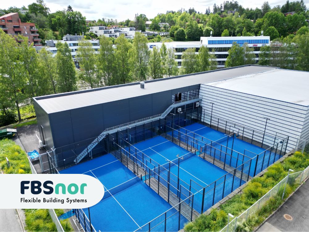 Fasaden av både ny og gammel del av stålhallen - lekker padelhall med utendørs padeltennis baner
